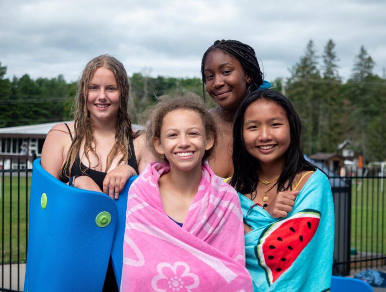 Four female summer camp guests enjoying the friendships they've made at Muskoka Woods