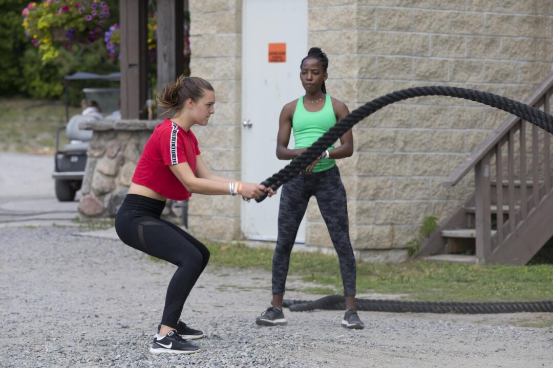 two woman working out with ropes
